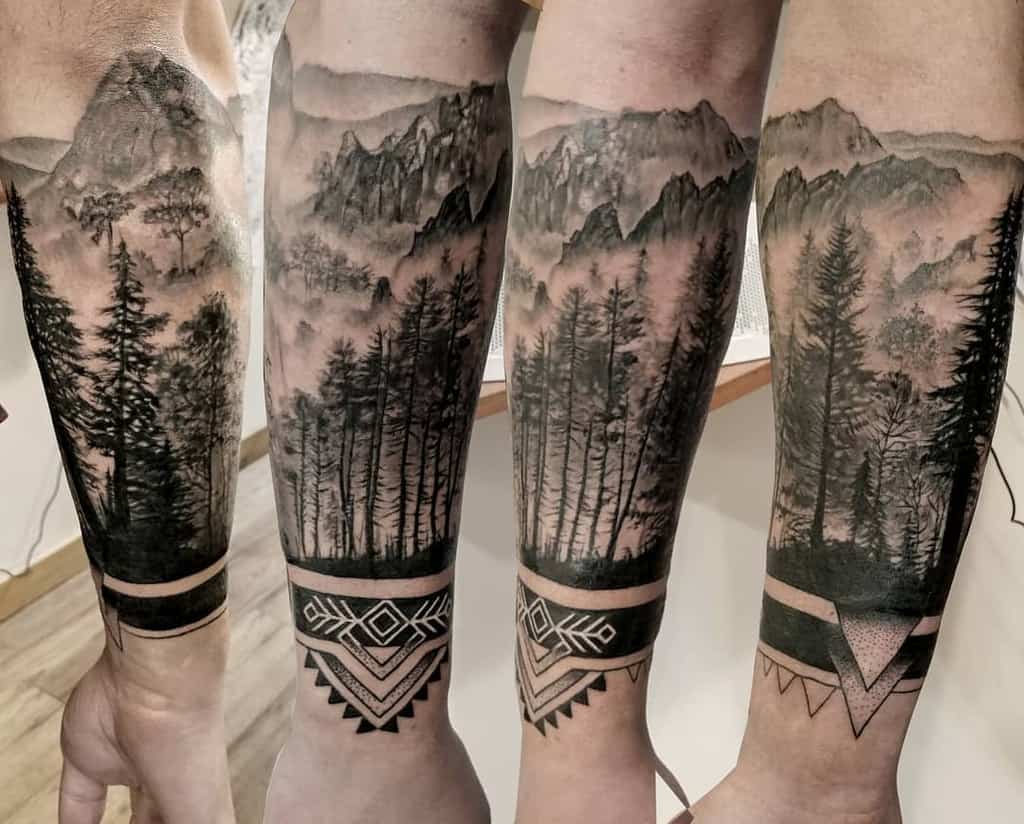 Forearm tattoo of trees and mountains with geometric shapes