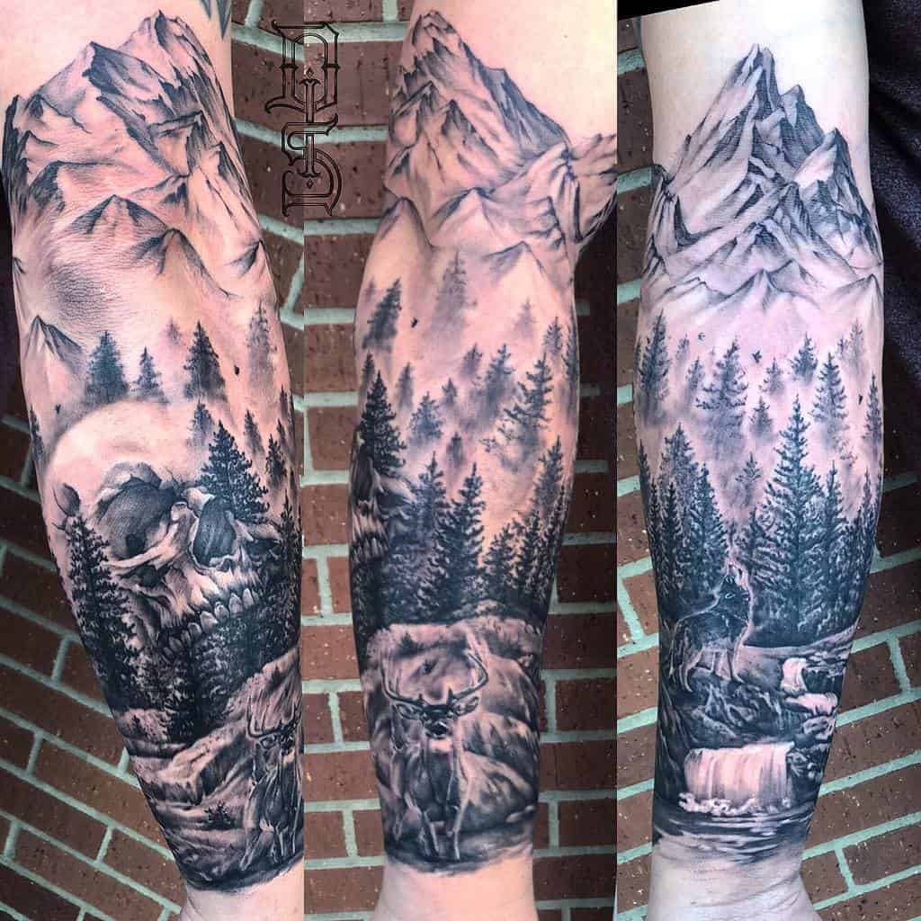 Forearm tattoo with mountains, trees, deer, a waterfall, and a river