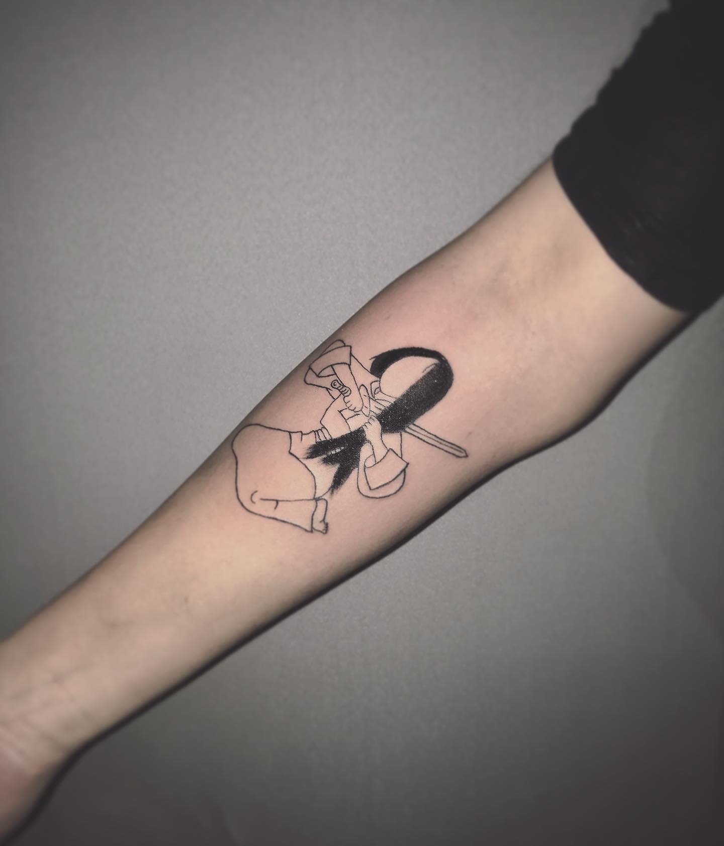 Forearm Mulan tattoo drawing a sword