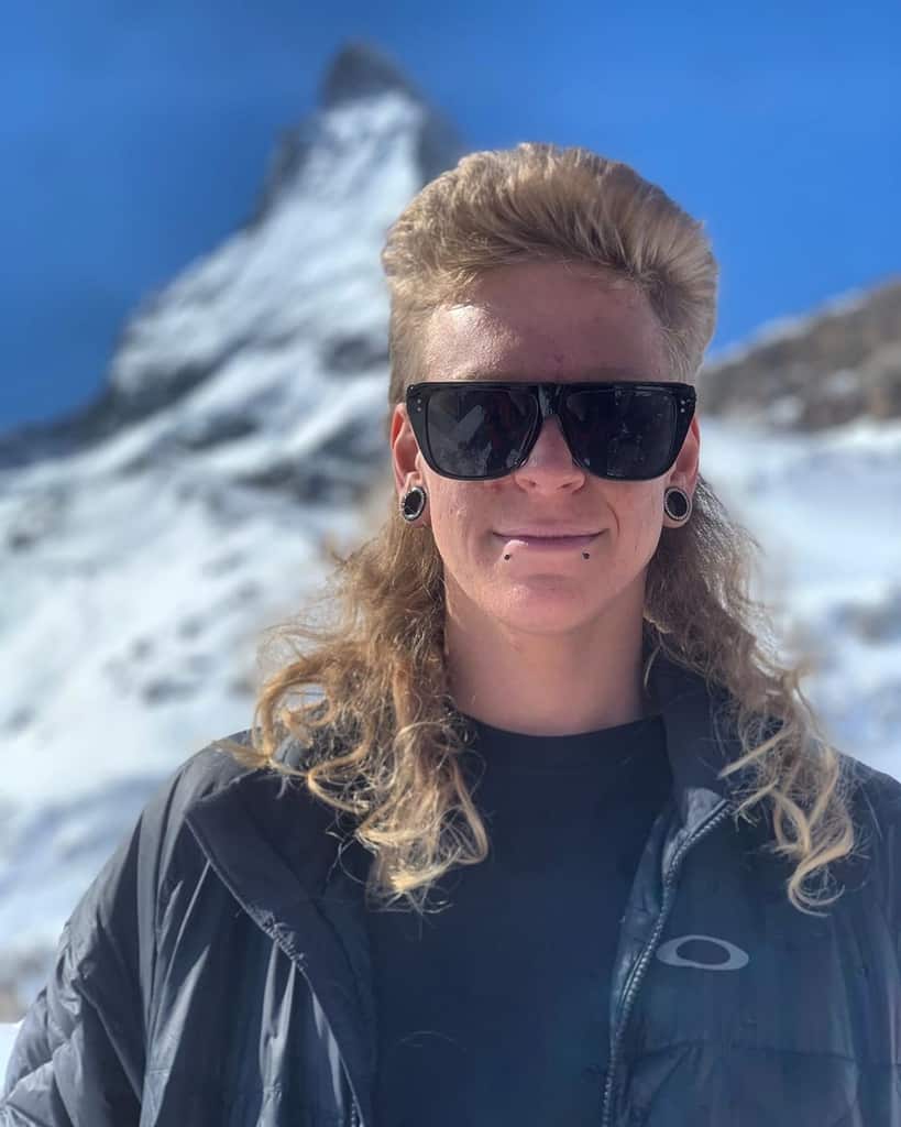 Man with mullet hairstyle and sunglasses