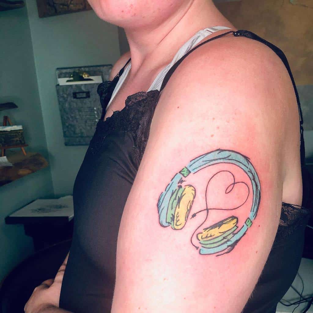 A woman with a tattoo of colorful headphones on her arm