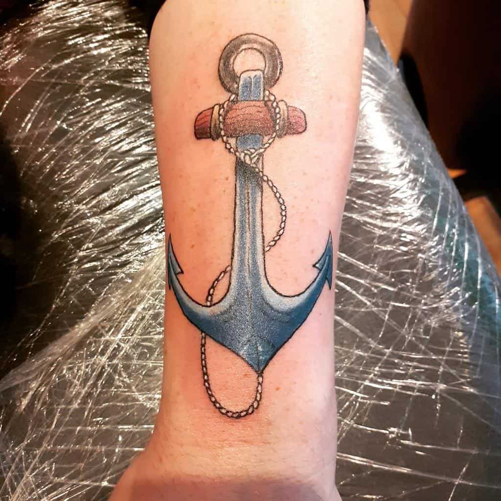 Forearm tattoo of a navy blue anchor with a rope wrapped around it