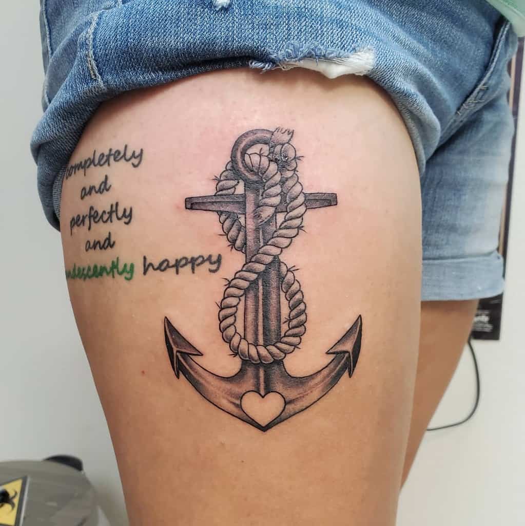 Anchor with rope tattoo on a person's thigh
