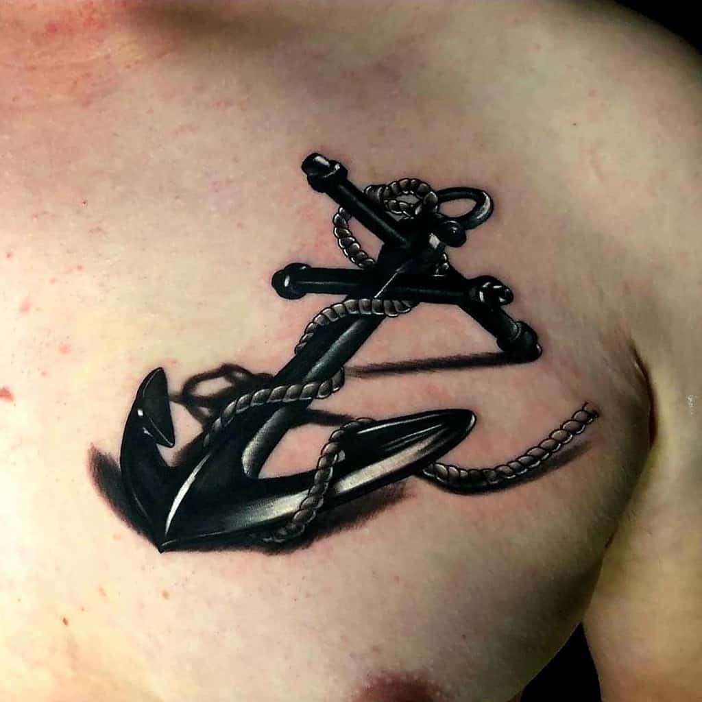 A black and gray anchor tattoo with rope on upper chest