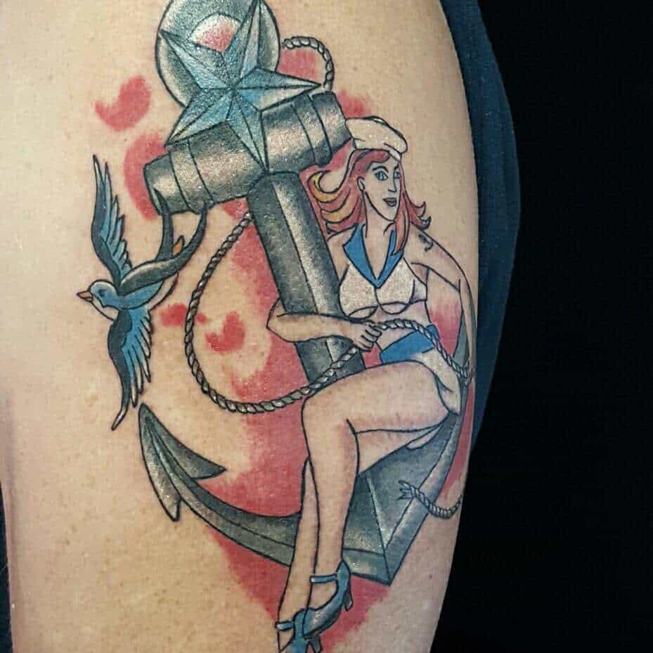 Tattoo of a pin-up sailor girl with an anchor and a bird