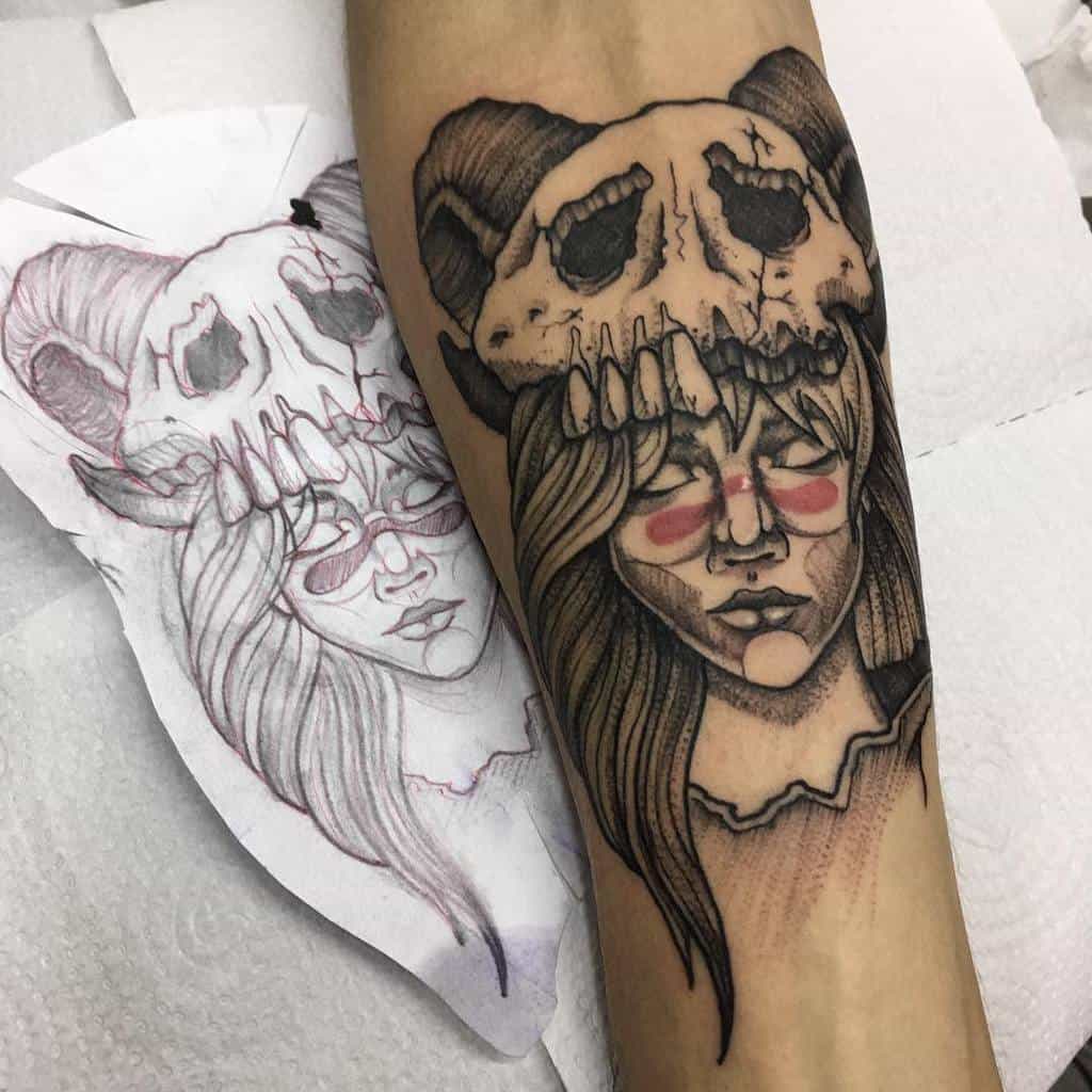 Black and grey tattoo of Nelliel Tu Odelschwanck from Bleach, featuring her signature ram skull Hollow mask, long flowing hair, and red facial markings 