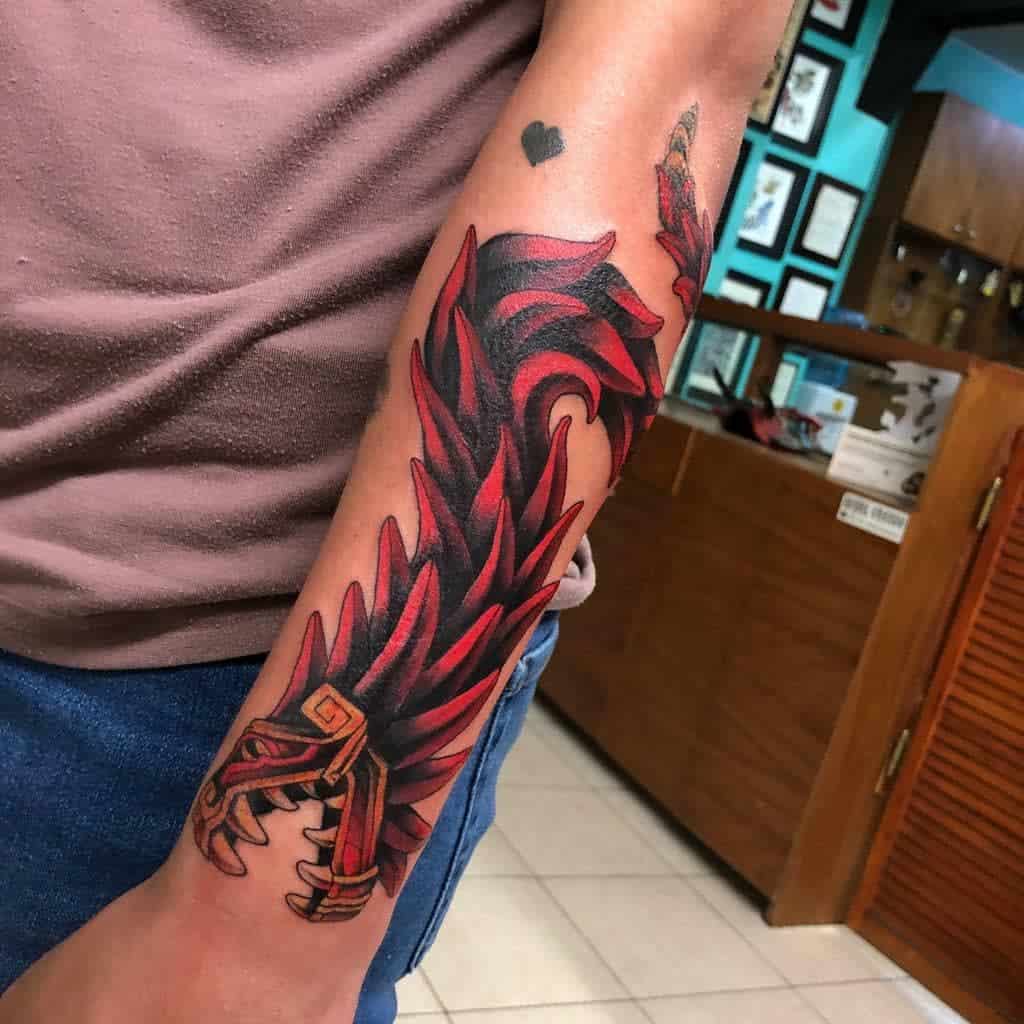 Neo-traditional Quetzalcoatl tattoo with vibrant red feathers and gold accents, bold and dynamic design
