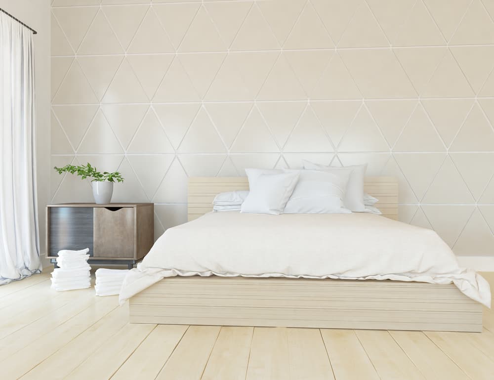 neutral minimalist bedroom with pattern accent wall