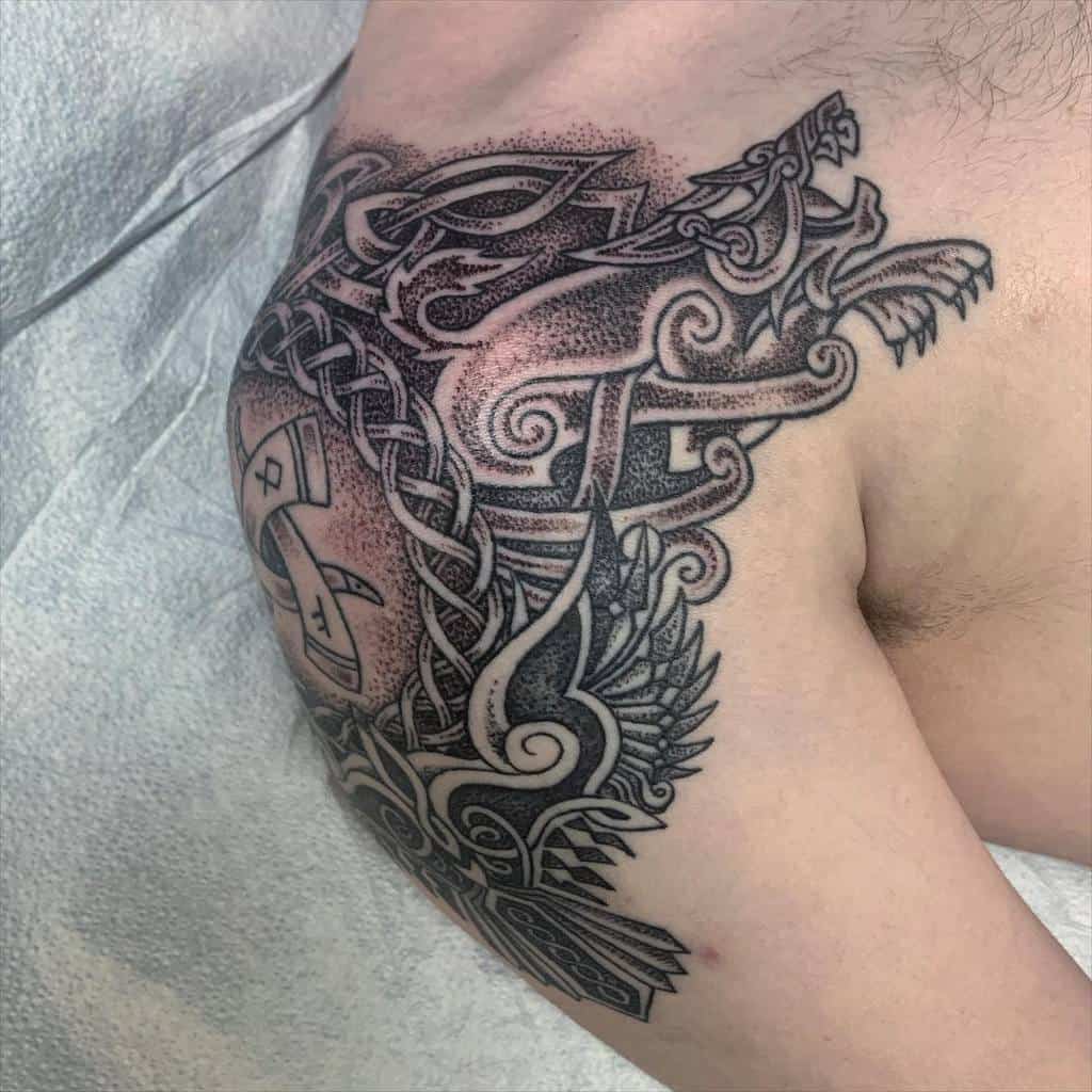 Nordic shoulder tattoo with a detailed dragon, knotwork, and runes, using bold lines and dot shading