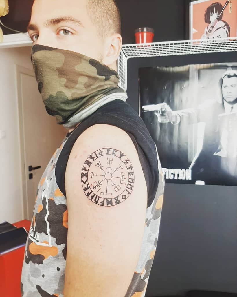 Nordic-inspired shoulder tattoo showcasing the Vegvisir symbol surrounded by runes, representing guidance and protection