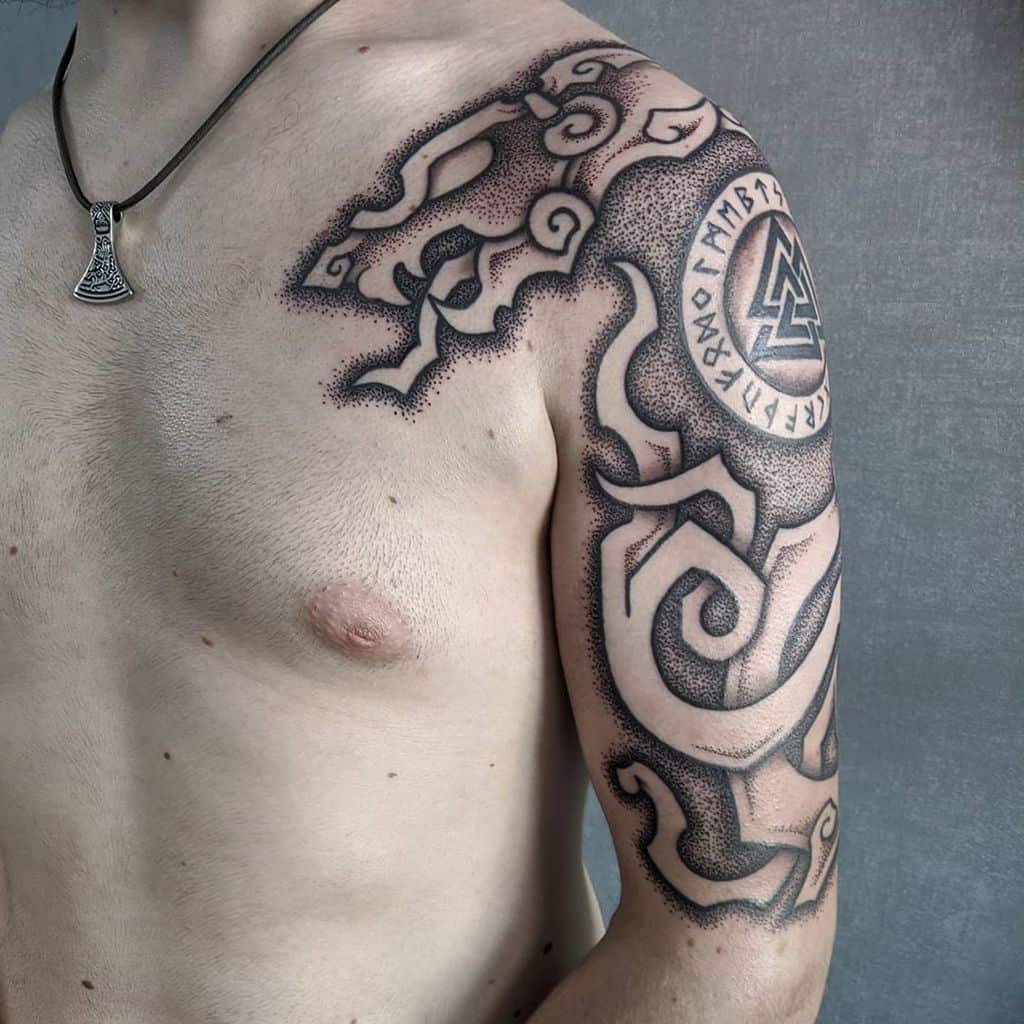 Nordic shoulder tattoo with runes, Valknut symbol, swirling tribal designs, and dot shading creating a bold and intricate look