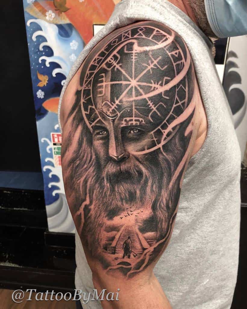 Nordic-inspired tattoo featuring a Viking warrior's face with a Vegvisir symbol on the helmet, symbolizing guidance and strength