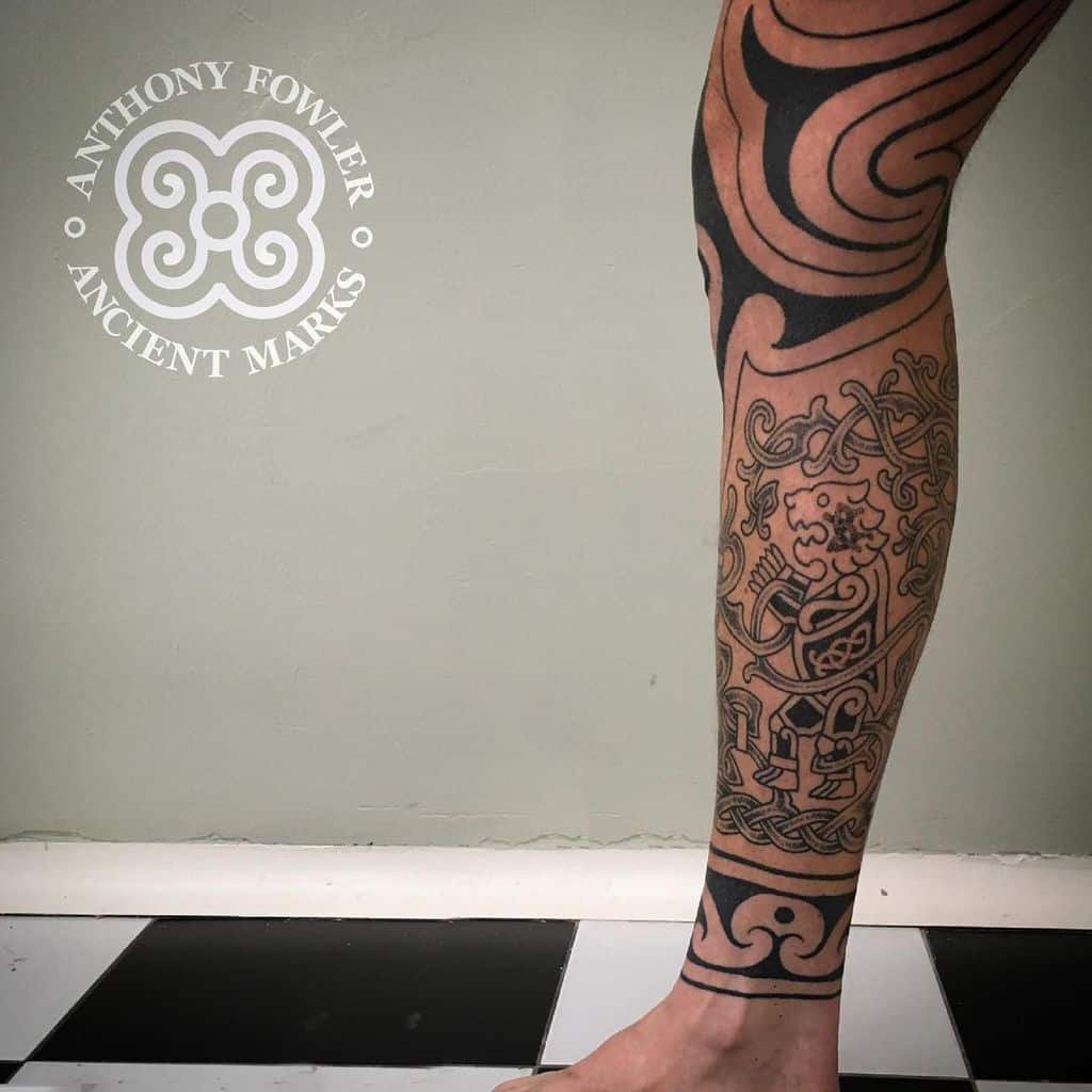Tattooed leg with intricate tribal patterns and designs