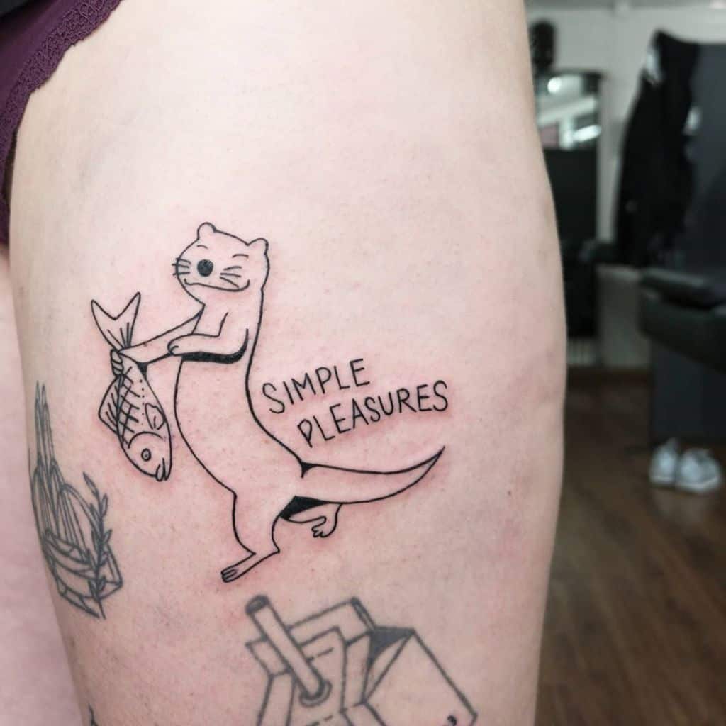 Tattoo of an otter and ferret holding a fish with "Simple Pleasures" on a person's arm