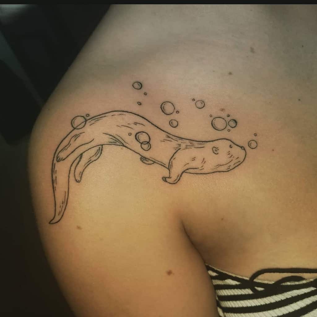 Otter line art tattoo with bubbles adorns a shoulder