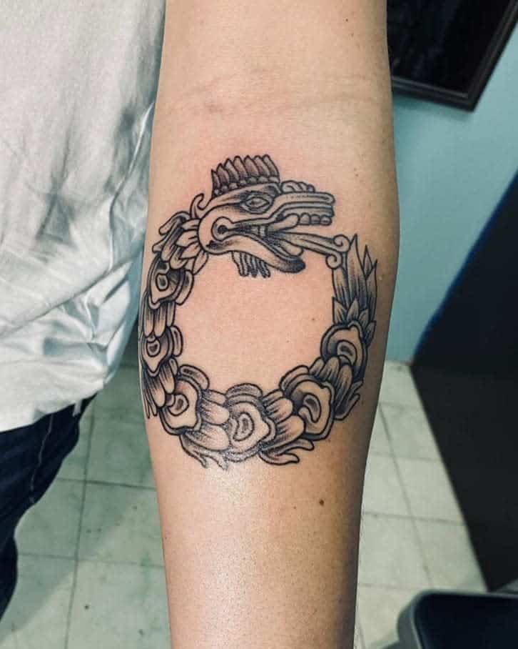 Ouroboros-style Quetzalcoatl tattoo, featuring a serpent biting its own tail, representing the cycle of life