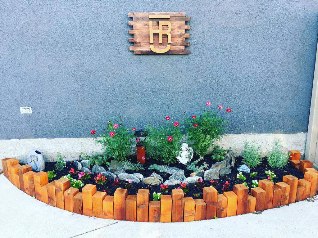 small backyard garden bed blue wall