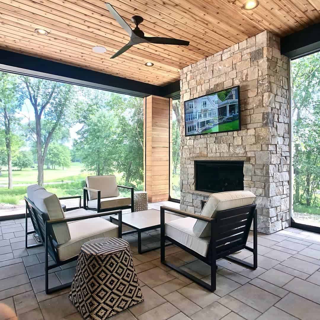 enclosed paver patio with stone fireplace 