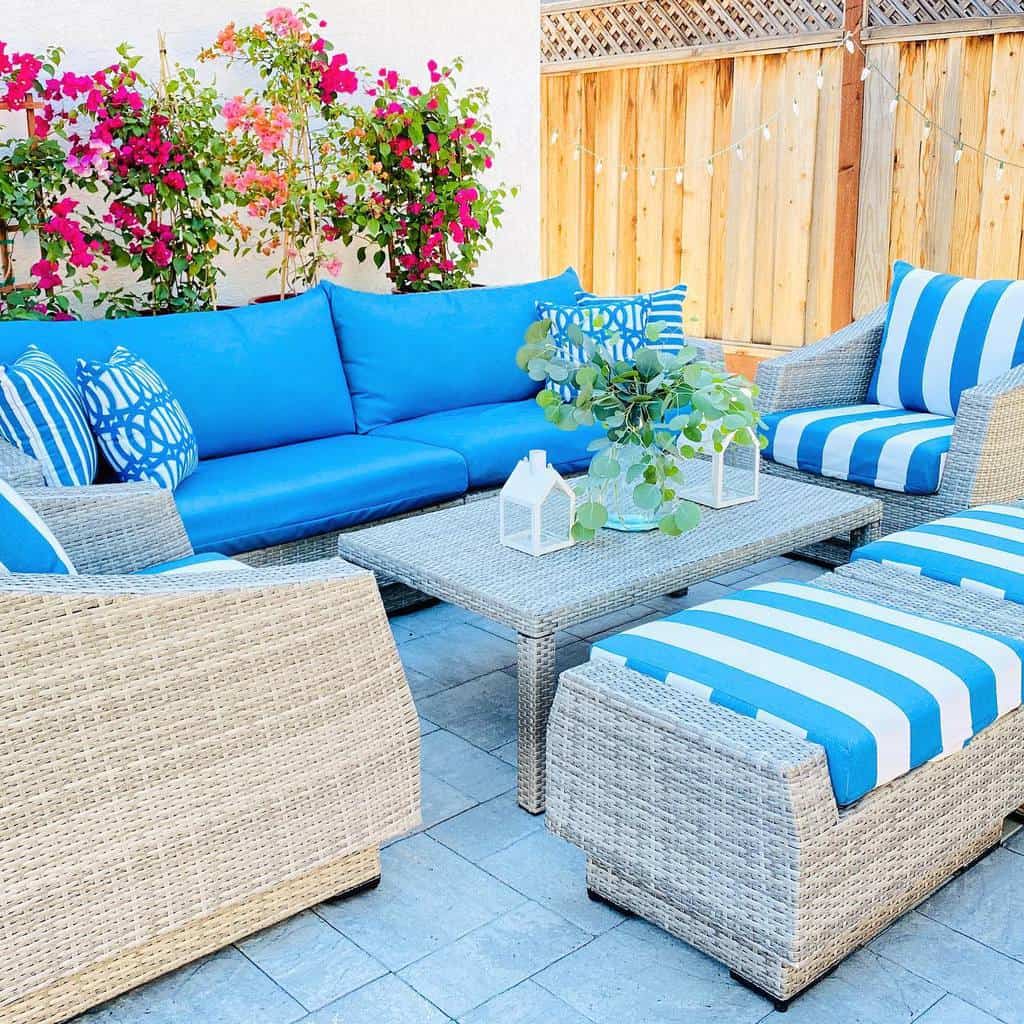 wicker furniture with blue cushions stone paver patio 