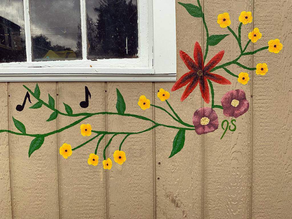 flower mural on outside shed wall