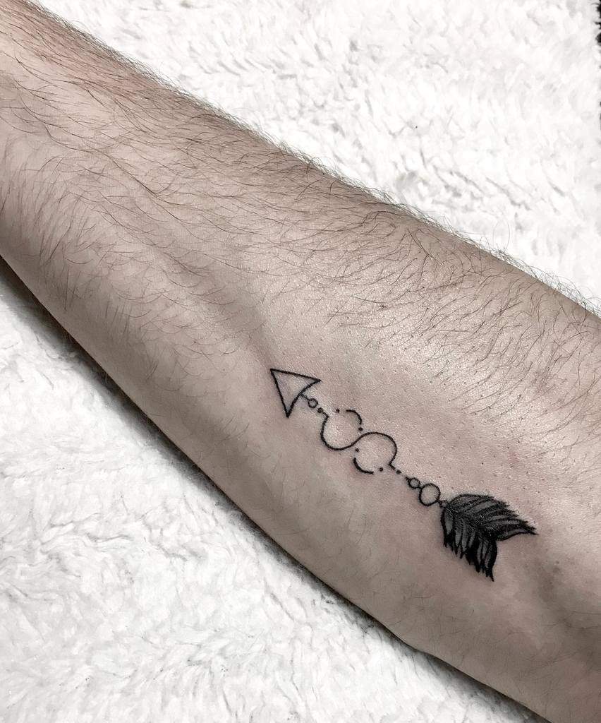 Geometric arrow tattoo on the outer forearm, featuring intricate dots and feather details