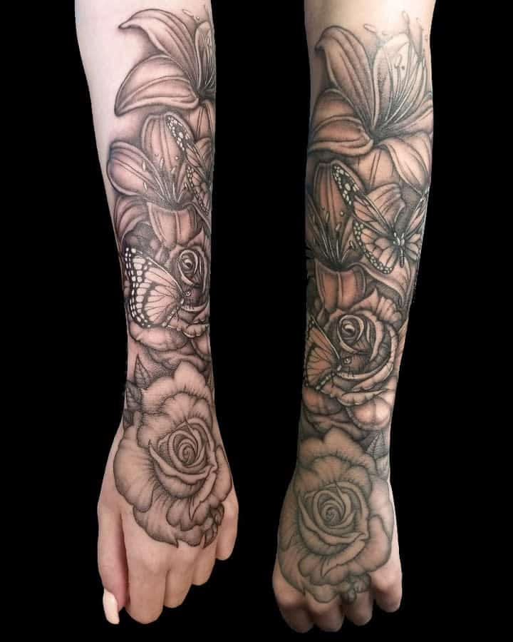 Outer forearm tattoos featuring flowers and butterflies in black and gray ink offer a perfect blend of elegance and grace