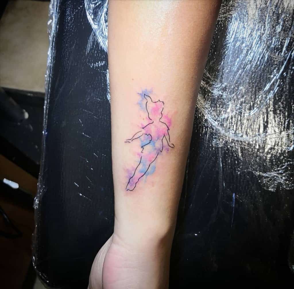 Minimalist tattoo of Peter Pan’s silhouette in fine black lines, surrounded by a soft watercolor blend of pink and blue