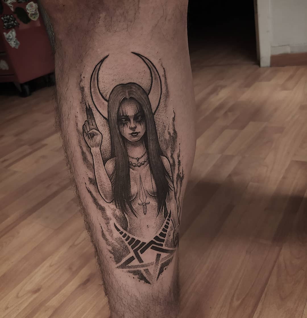 Leg tattoo of a Wicca Pagan woman with long hair and horns