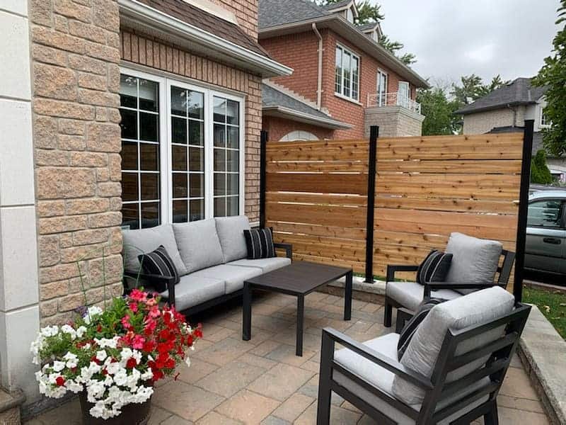 stone paver patio with wood privacy fence