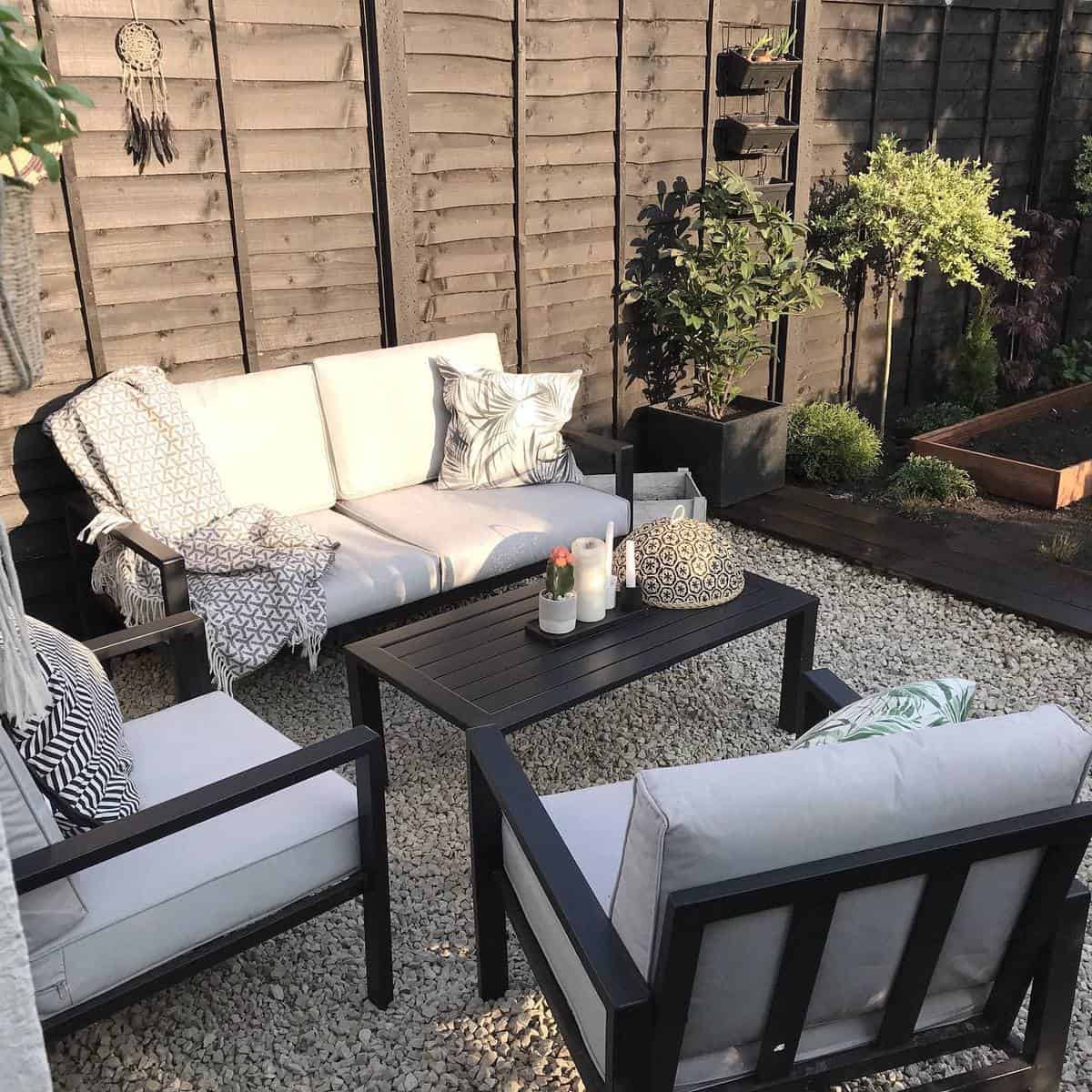 gravel patio with black painted furniture