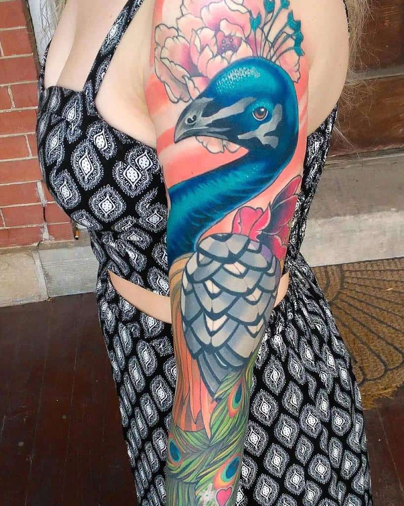 Colorful peacock tattoo on a woman's arm
