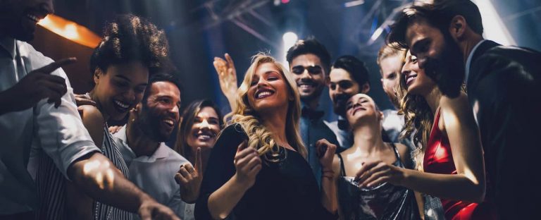 Group of people dancing and partying at a nightclub