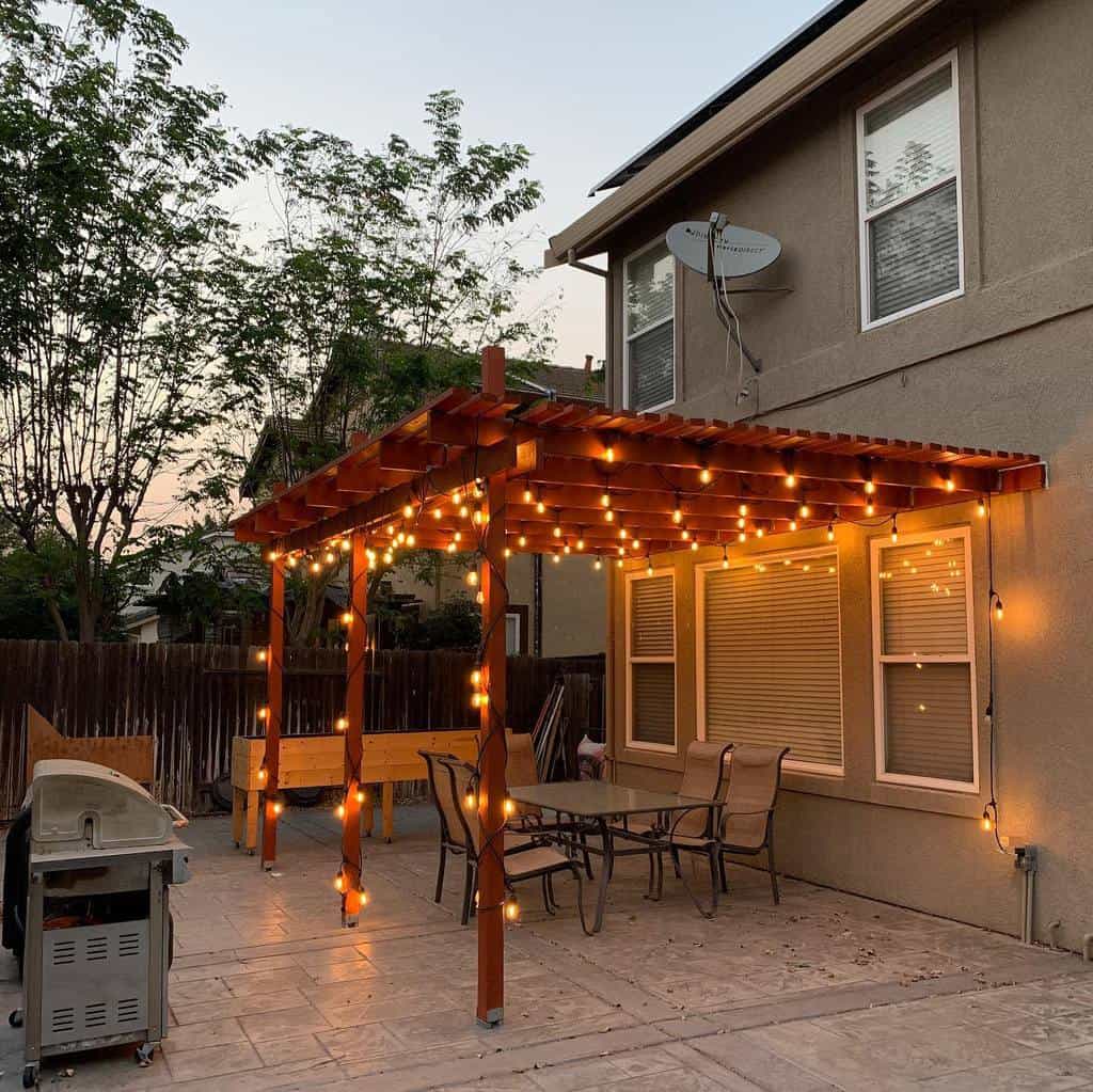 large paver patio wood gazebo fairly lights bbq glass tabletop and chairs