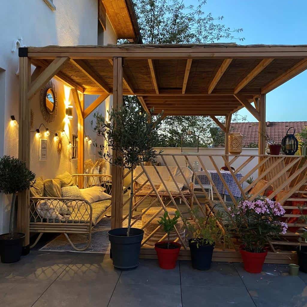 paver patio wood pergola potted plants backyard furniture