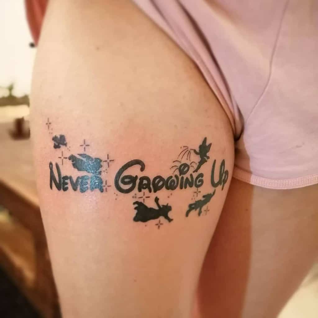"Never Growing Up" tattoo with Tinker Bell, Peter Pan, Wendy, and the Darling children silhouettes