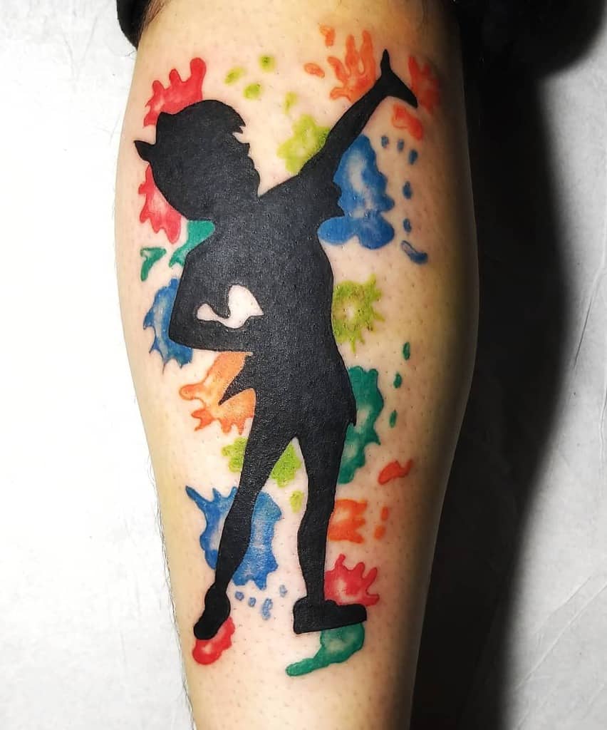 Vibrant Peter Pan silhouette tattoo with a colorful splash background such as orange, blue, red, green and yellow