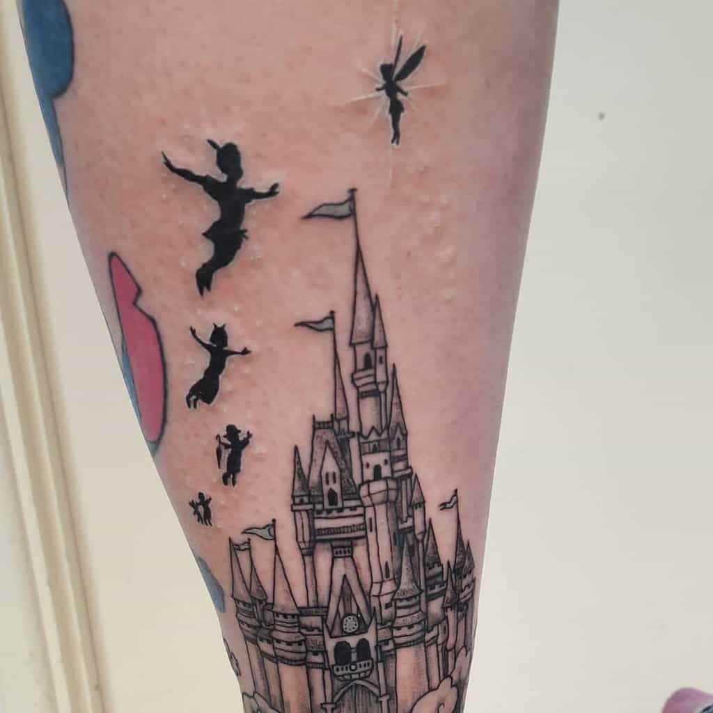 Peter Pan, Wendy, and Tinker Bell flying over a detailed castle tattoo, symbolizing adventure and magic