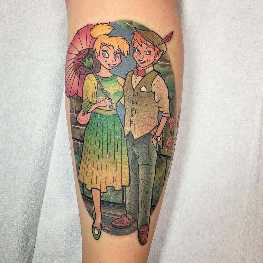 Colorful tattoo of Peter Pan and Tinker Bell dressed in vintage clothing, standing together on a bridge, with Tinker Bell holding a parasol