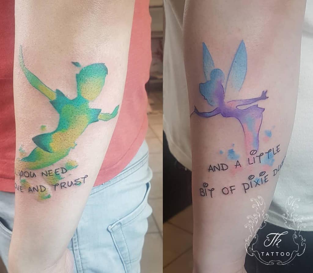Matching watercolor tattoos of Peter Pan in green and yellow hues and Tinker Bell in purple and blue, with the quote "All you need is faith and trust... and a little bit of pixie dust"