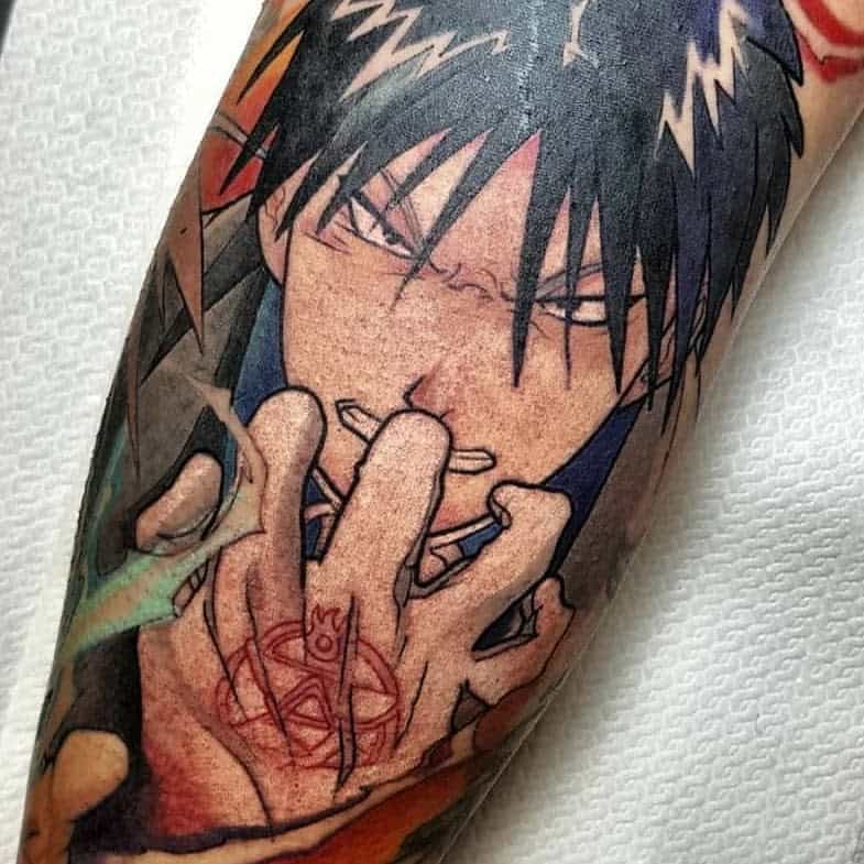 Fullmetal Alchemist tattoo of Roy Mustang in a battle-ready pose, showing his ignition glove’s transmutation circle and intense expression
