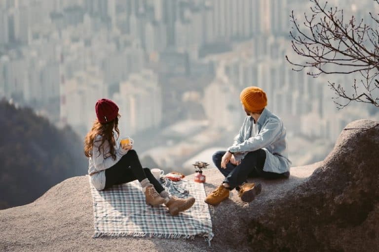 Couple Having Picnic Date With View of City