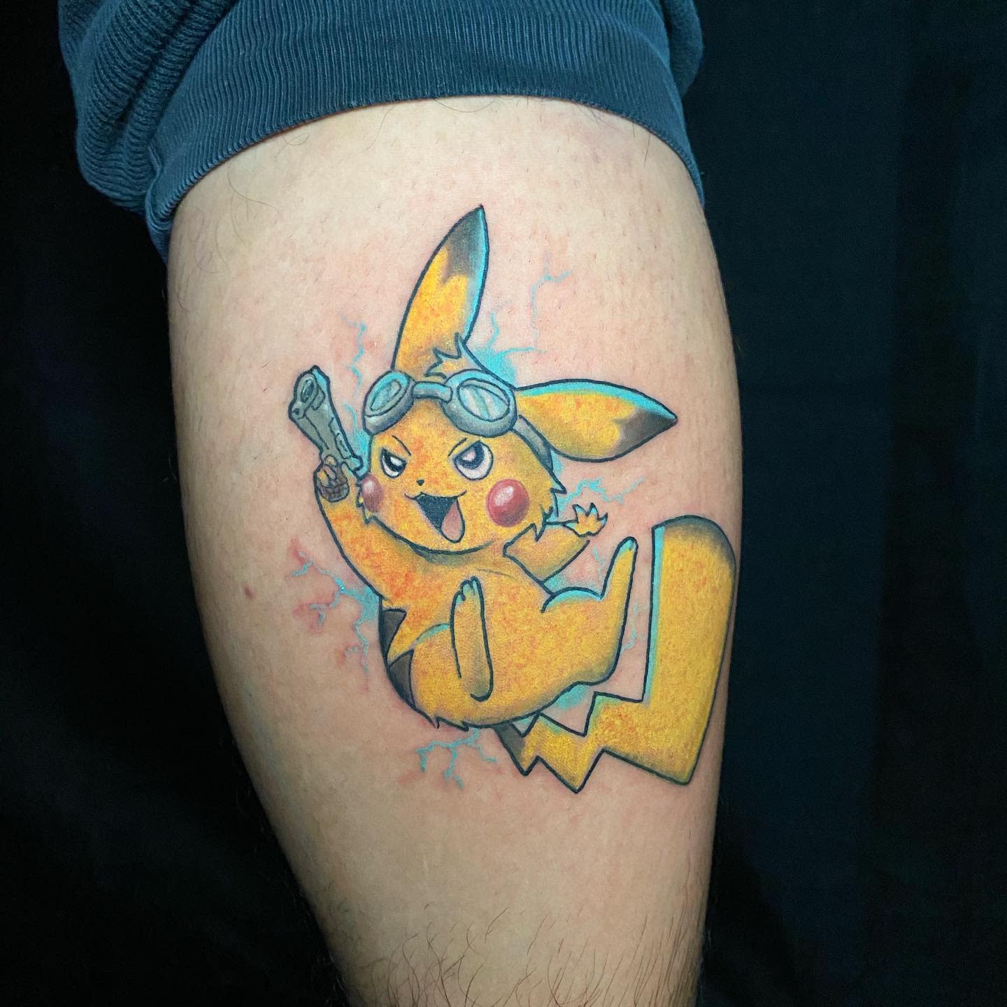 Tattoo of Pikachu wearing goggles and holding a wrench on an arm