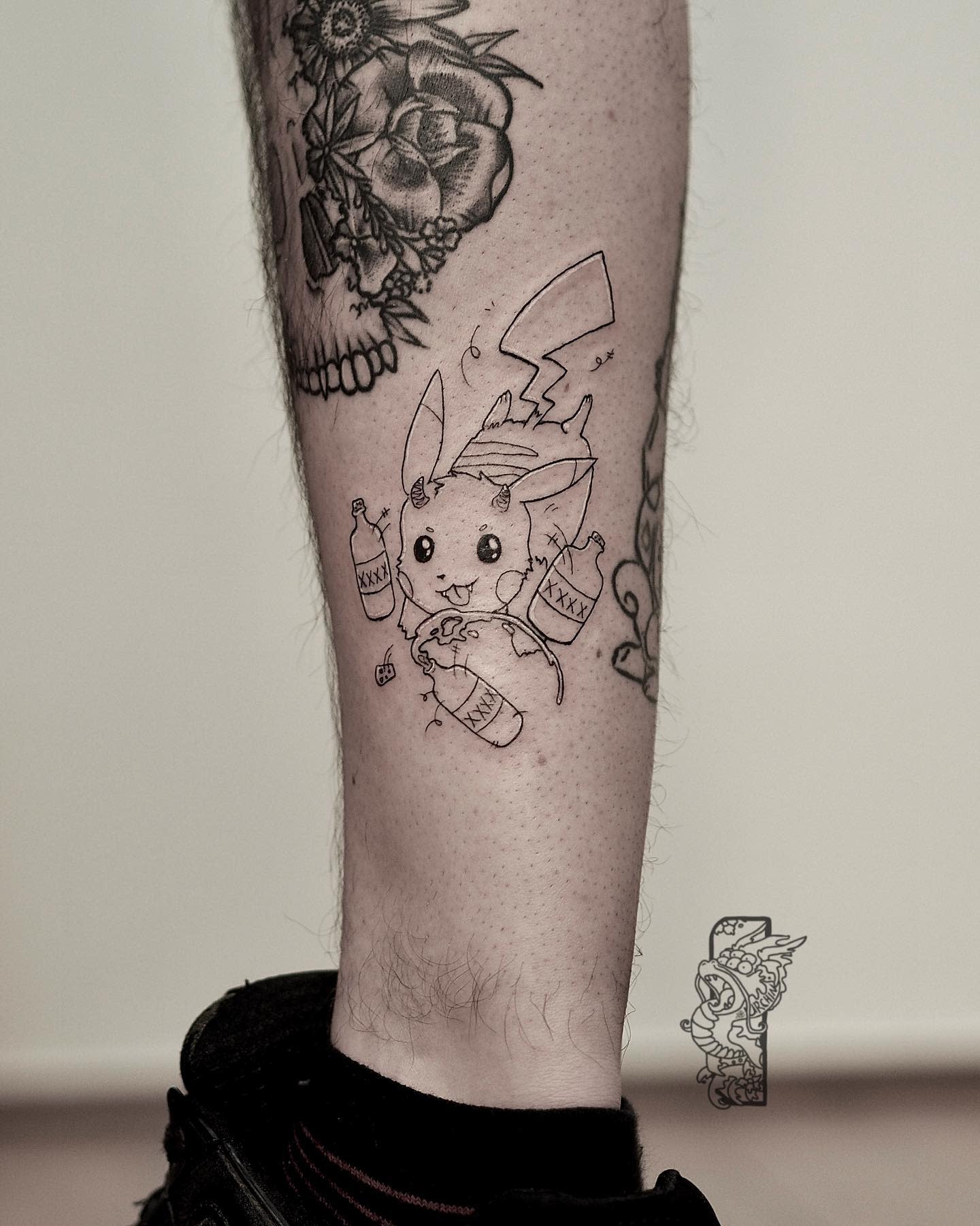 Tattoo of Pikachu holding bottles on the back of a lower leg