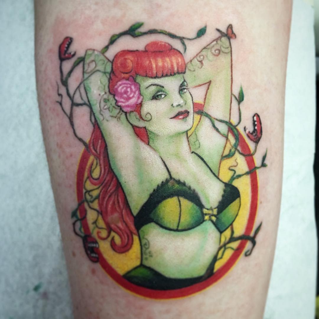 Tattoo of a Poison Ivy with red hair and vines wearing a black bra