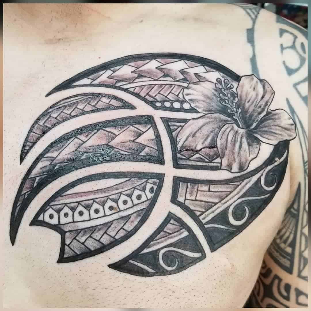 Chest tattoo featuring a stylized basketball with intricate Polynesian tribal patterns and a hibiscus flower