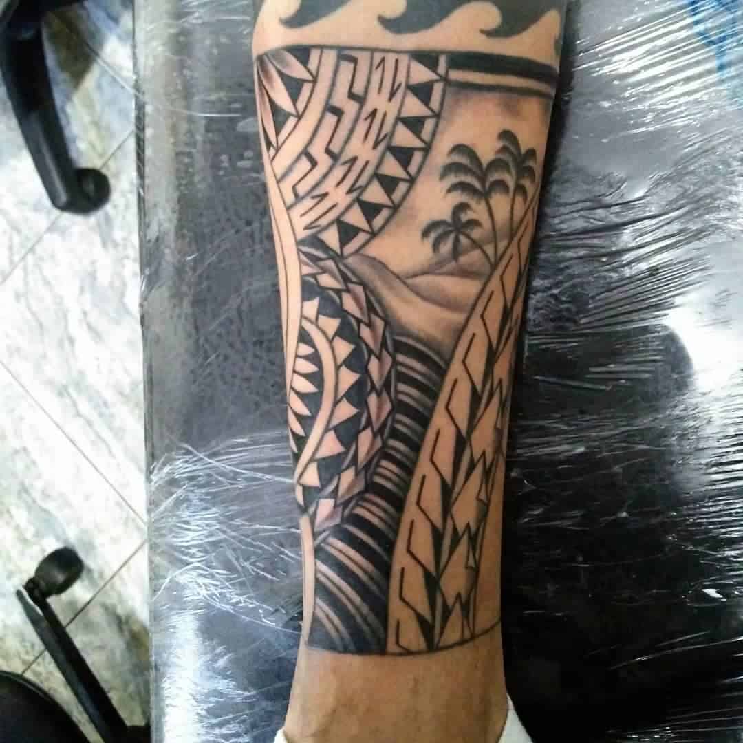 Forearm tattoo with geometric patterns and a landscape of palm trees