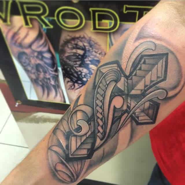 Forearm tattoo with geometric design and abstract elements