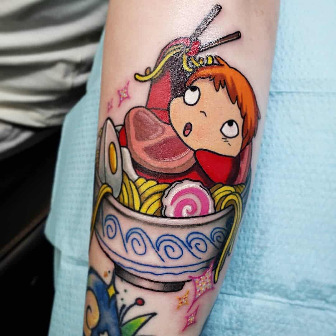 Colorful tattoo of Ponyo enjoying a bowl of ramen from Studio Ghibli's Ponyo on the arm