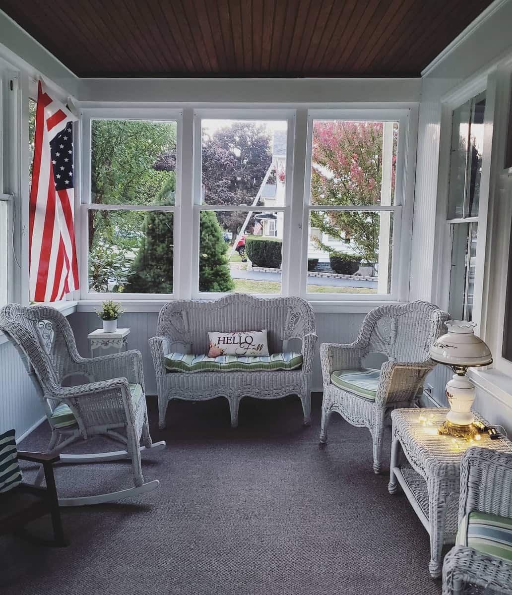 enclosed porch patio with white wicker furniture 