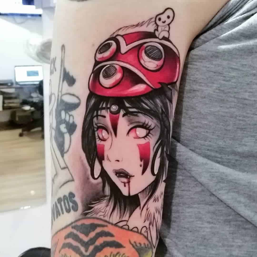 Tattoo of San from Princess Mononoke with her iconic red mask and a Kodama spirit on her shoulder